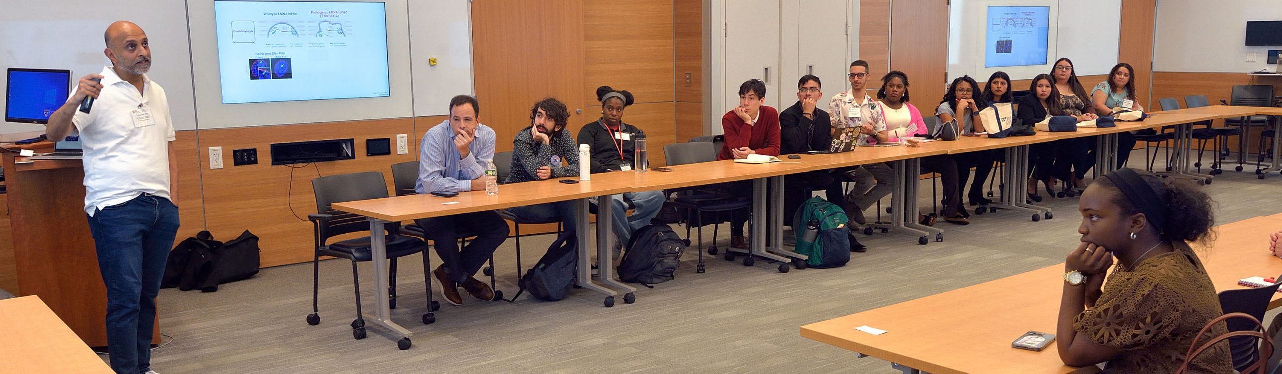 professor speaking to a room full of participants