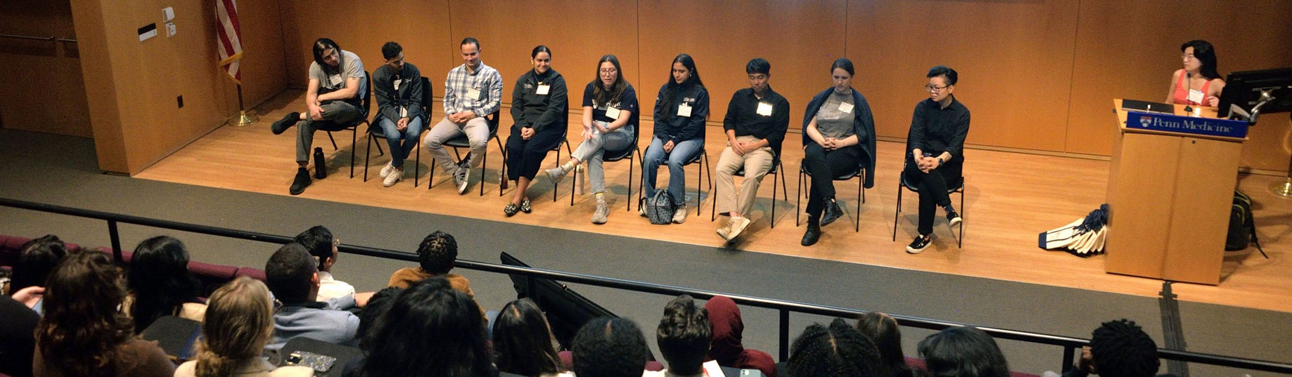 panelist on a stage in an auditorium