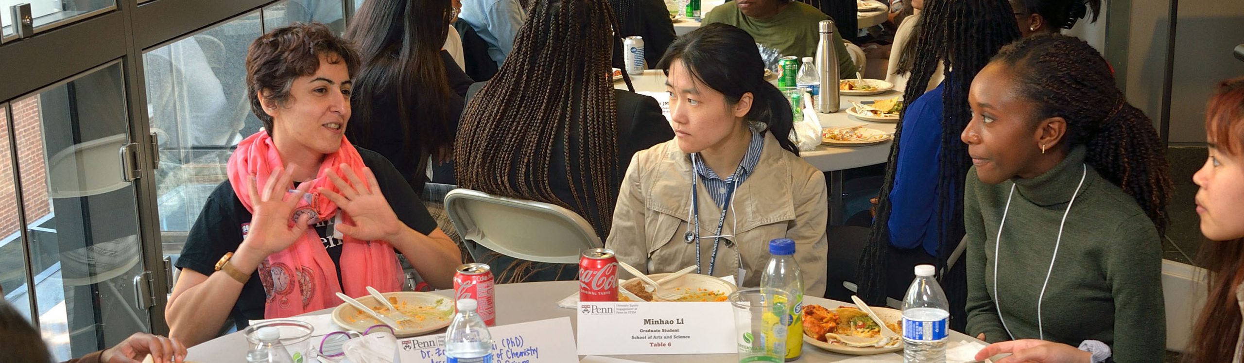 Penn professor speaking with participants during an informal lunch